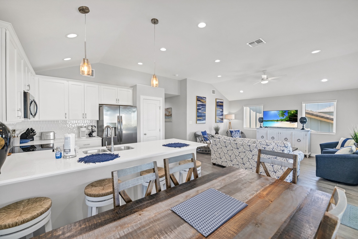 Gather around your spacious kitchen island for morning coffee or evening cocktails in this bright, open living space.