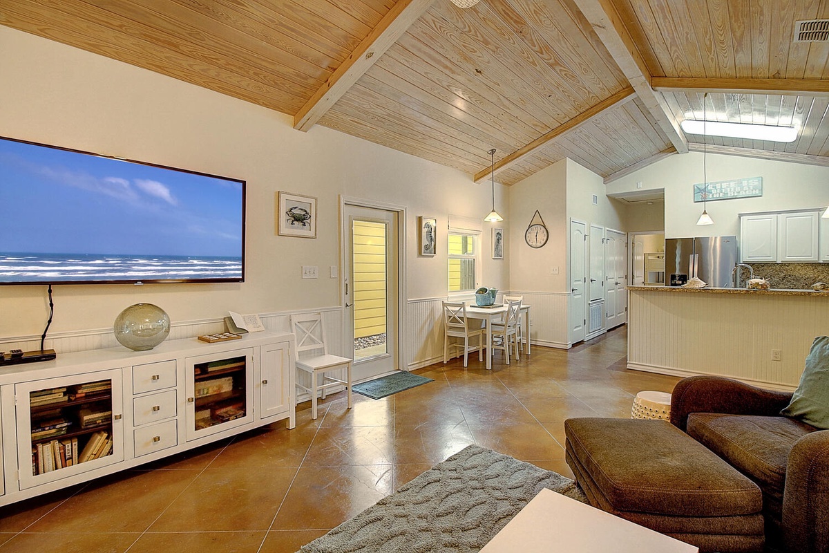 Relax in your bright, open-concept living space with vaulted wood ceilings and ocean views on the big screen TV.