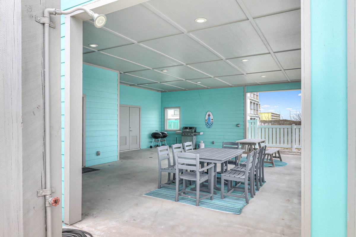 Gather around this spacious covered patio where turquoise walls create a cheerful backdrop for memorable meals together.