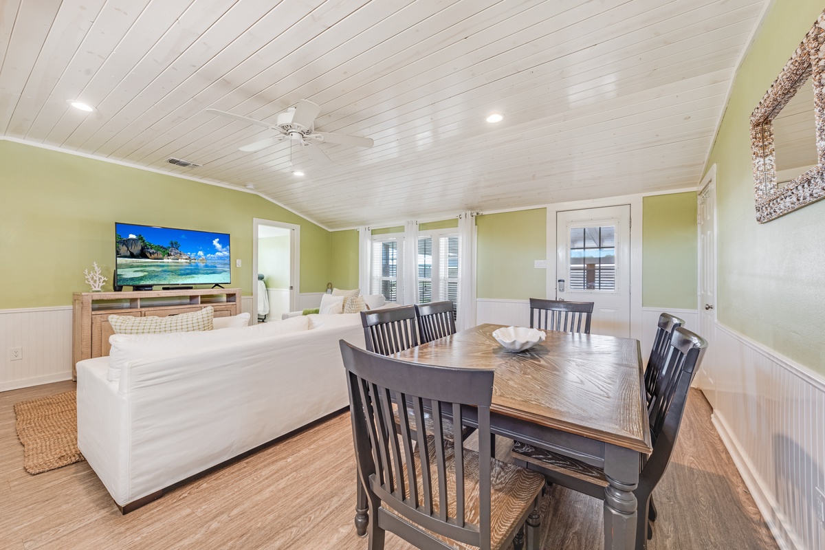 Gather around your spacious dining table while enjoying the open layout that flows into the cozy living area with large TV.