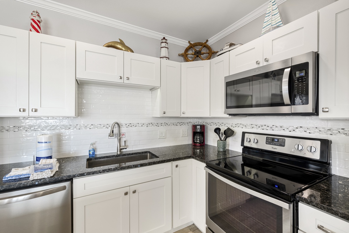 Your bright coastal kitchen features modern appliances and charming nautical touches, perfect for preparing meals during your stay.