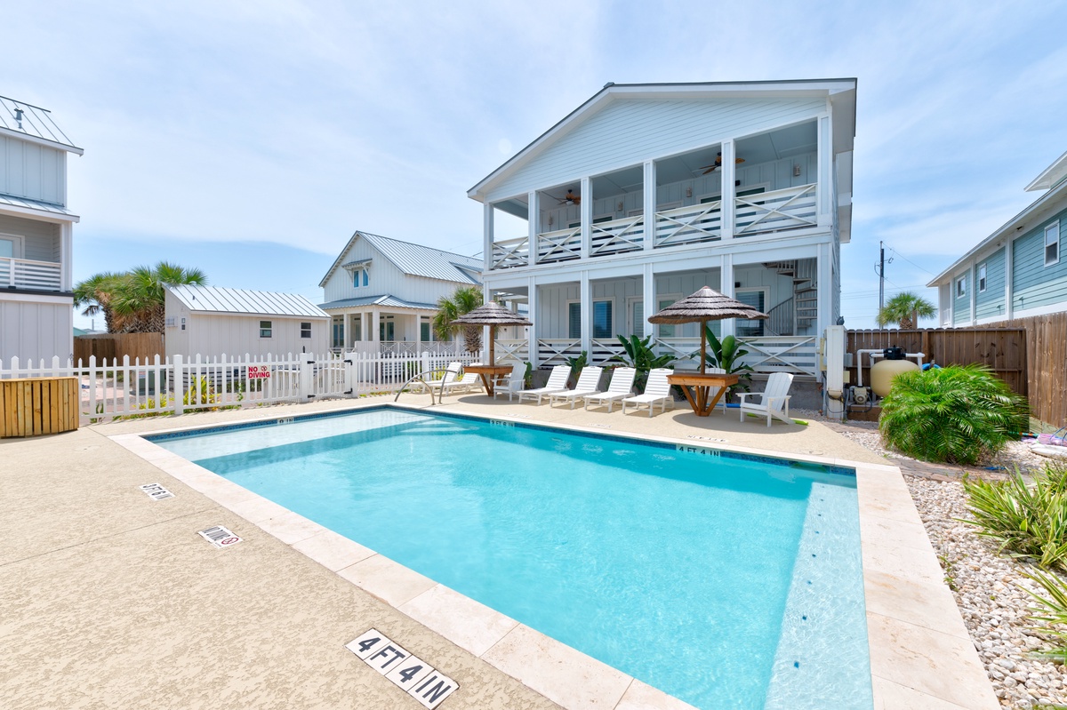Dive into your private pool oasis surrounded by tropical palms and poolside loungers, perfect for soaking up the coastal sunshine.