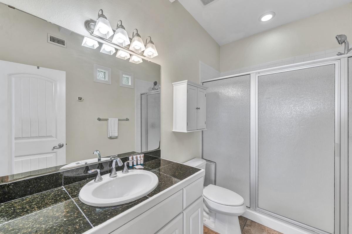 Your private bathroom features granite counters, bright vanity lighting, and a spacious shower for refreshing mornings.