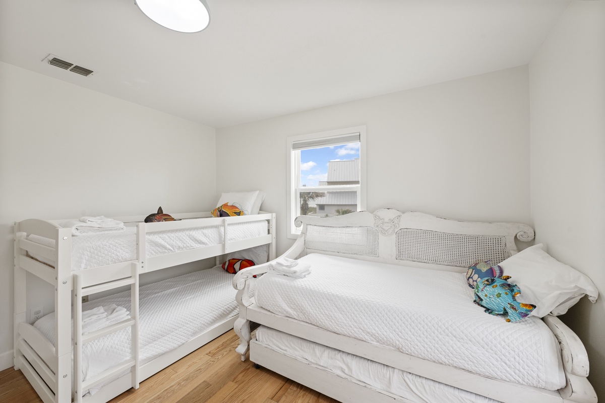 Your kids will love this bright bedroom with cozy bunk beds and a trundle, perfect for sleepovers and family bonding.