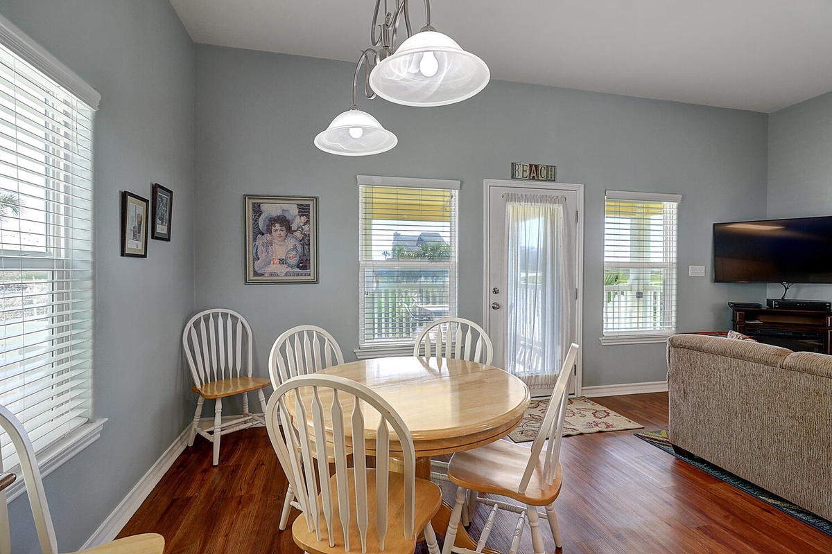 Your bright dining space features a welcoming table perfect for morning coffee or evening meals, with charming coastal touches throughout.