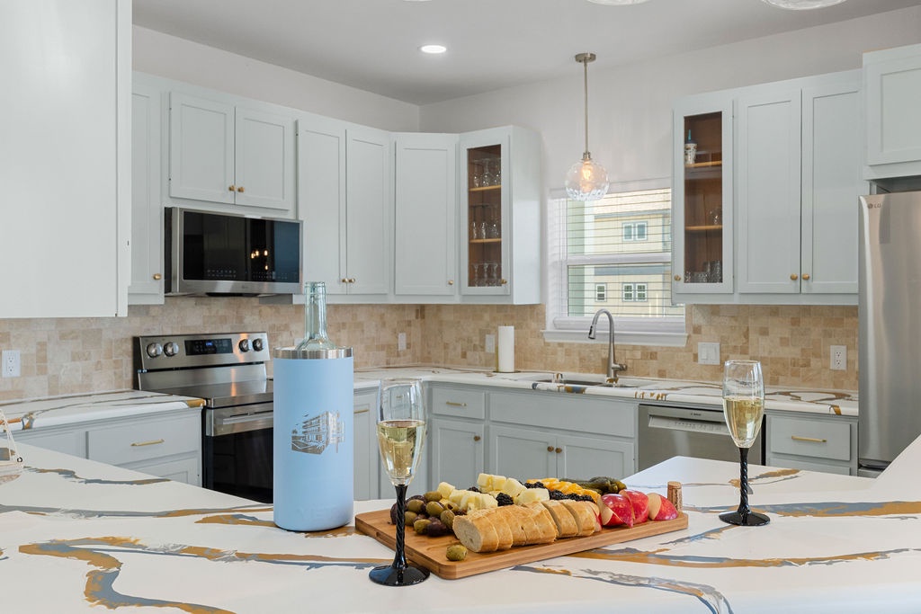 Your elegant kitchen awaits with marble countertops, modern appliances, and thoughtful touches like champagne and gourmet appetizers to welcome you home.