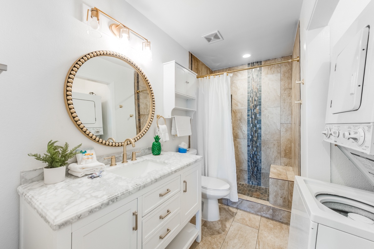 Your elegant bathroom features marble counters, brass fixtures, and a stunning tiled shower—the perfect space to refresh and unwind.