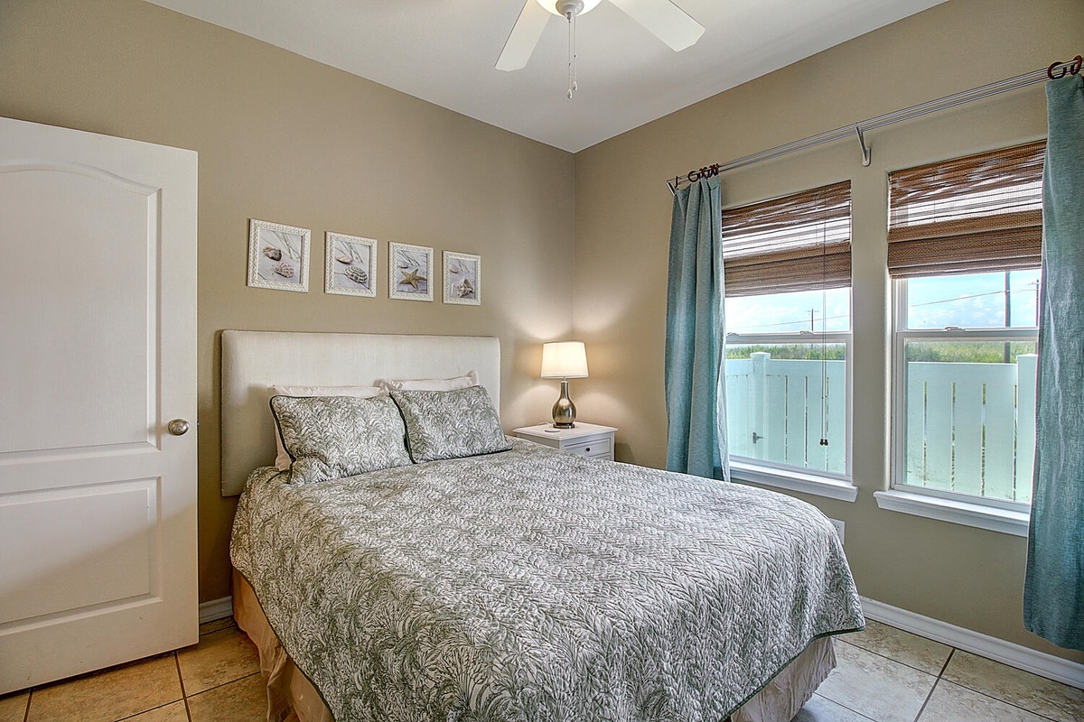 Unwind in your serene bedroom retreat with crisp linens, gentle natural light, and coastal artwork creating the perfect atmosphere for restful nights.