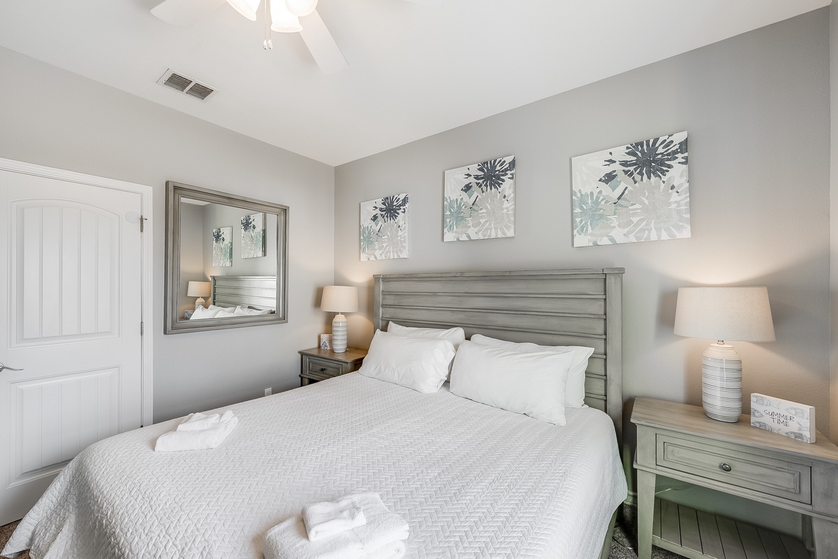 Drift into peaceful sleep in your beautifully appointed bedroom with crisp linens and calming coastal decor creating the perfect retreat.