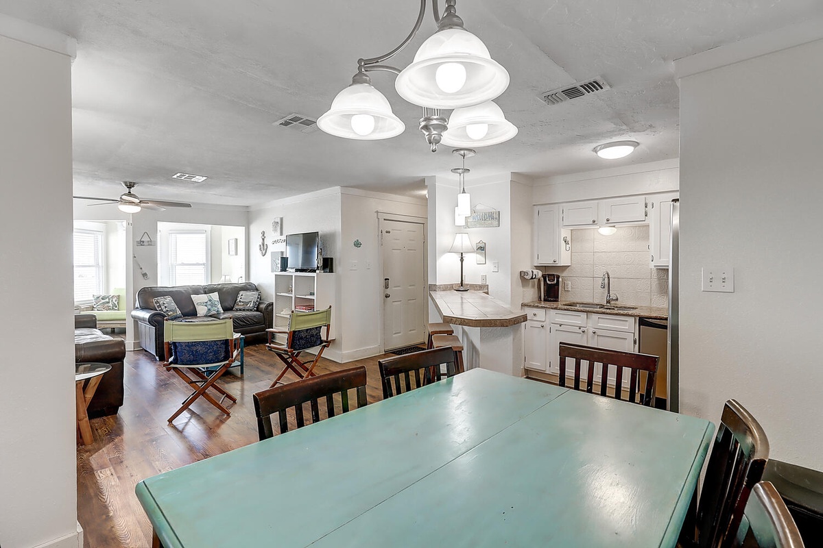 Your spacious open-plan living blends seamlessly - gather around the dining table, relax in the cozy lounge, and enjoy the fully equipped kitchen.