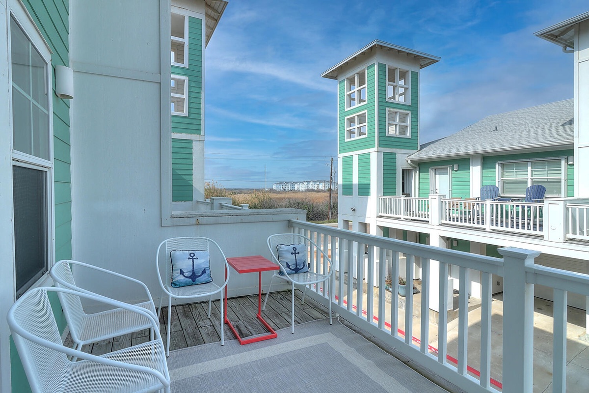 Relax on your private balcony with coastal views, surrounded by charming beachside architecture and refreshing ocean breezes.