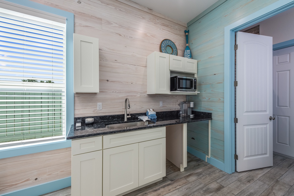 Your coastal-inspired kitchenette features granite counters and modern appliances, perfect for preparing meals with ocean views.