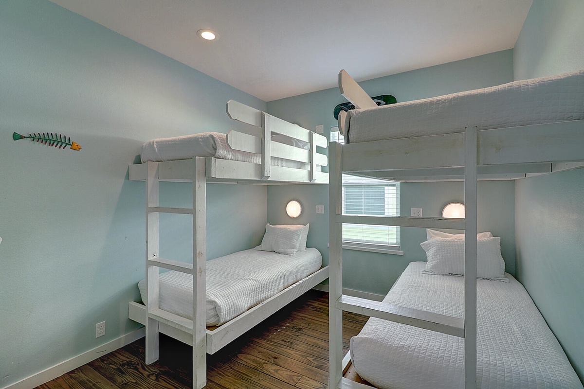 Your kids will love this nautical bunk room with cozy reading lights and ocean-themed decor for the perfect bedtime stories.