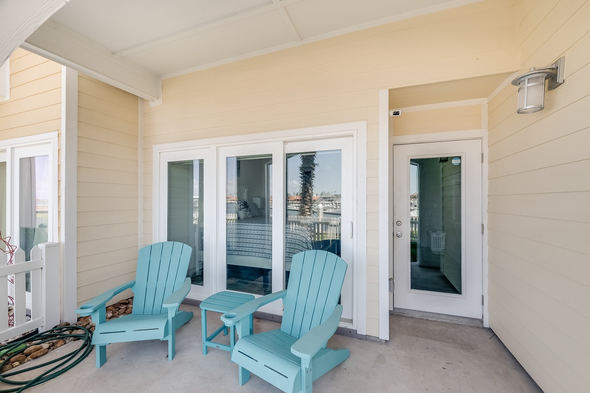 Unwind on your private patio with cheerful turquoise chairs where you can sip morning coffee or watch the day unfold.