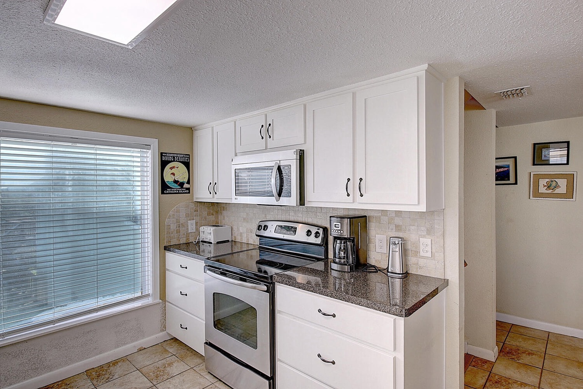 Your bright, fully-equipped kitchen features sleek granite counters, modern appliances, and plenty of cabinet space for home-cooked meals.