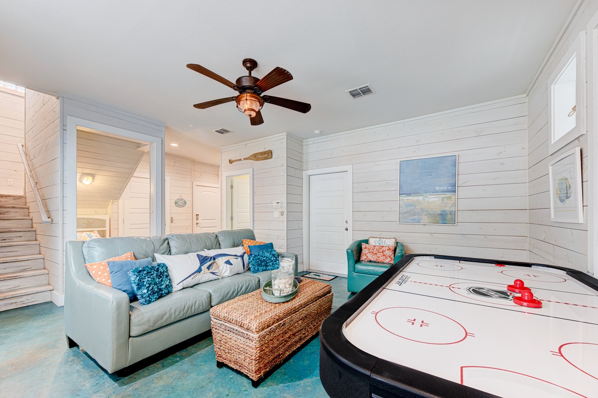 Your game room awaits with comfy seating and air hockey fun, perfect for family entertainment after beach days.