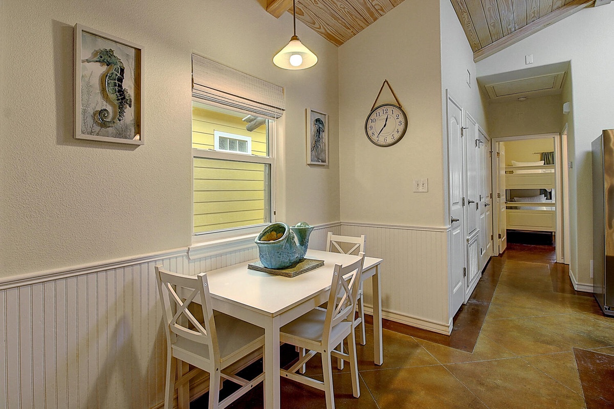 Your cozy dining nook invites leisurely meals with coastal charm, featuring warm wood accents and nautical touches that make every breakfast feel special.