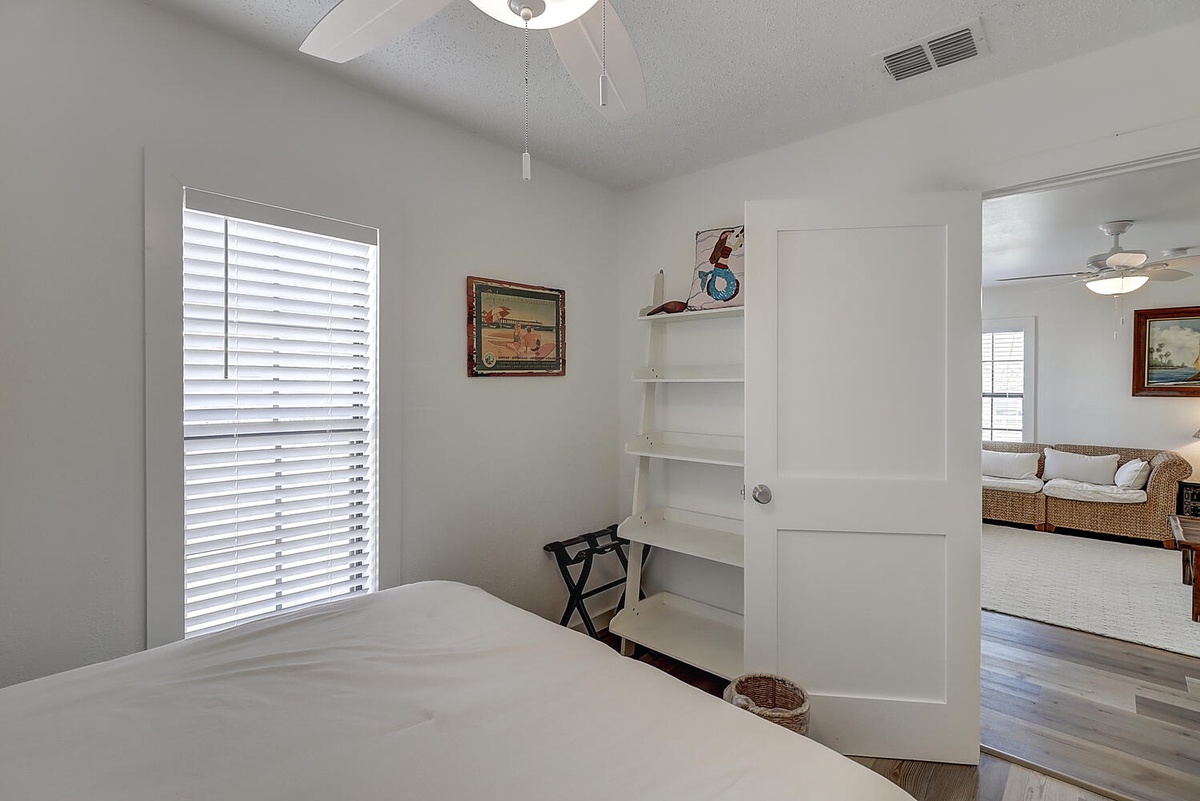 Bright bedroom with thoughtful storage and coastal charm awaits your peaceful nights.