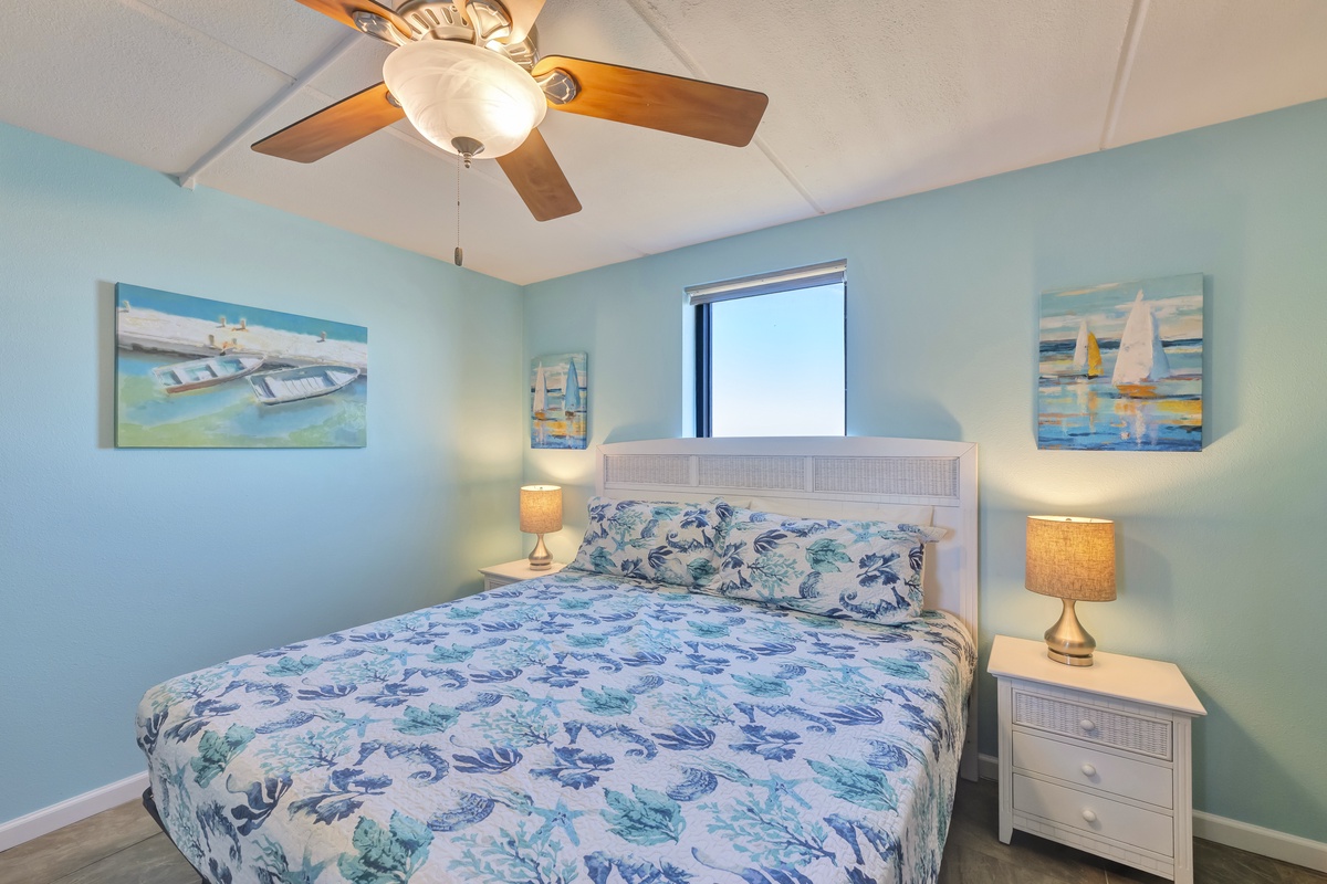Drift off in your serene coastal bedroom, where ocean-themed art and soft sea-glass walls create the perfect beach retreat ambiance.