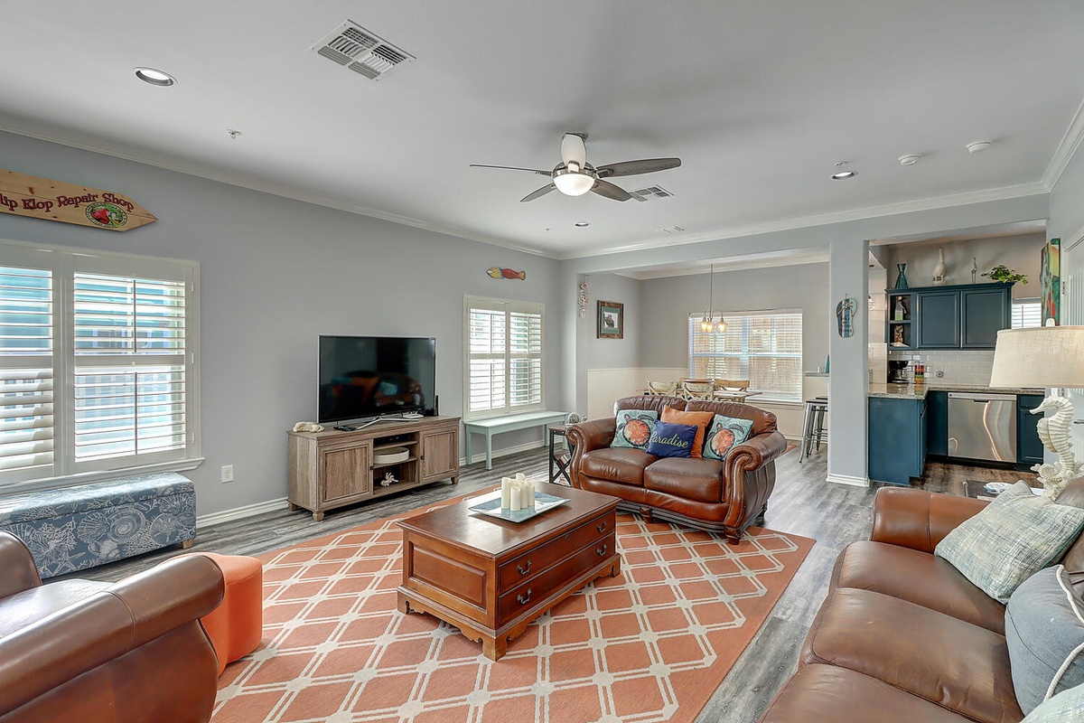 Relax in this open living space where leather seating and coastal decor create your perfect retreat.