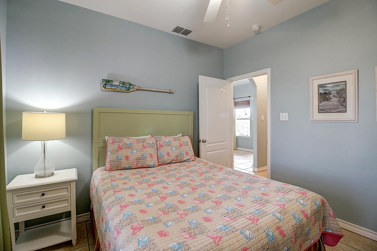 Drift off in this cozy bedroom featuring soft linens and peaceful coastal decor that creates your perfect retreat.