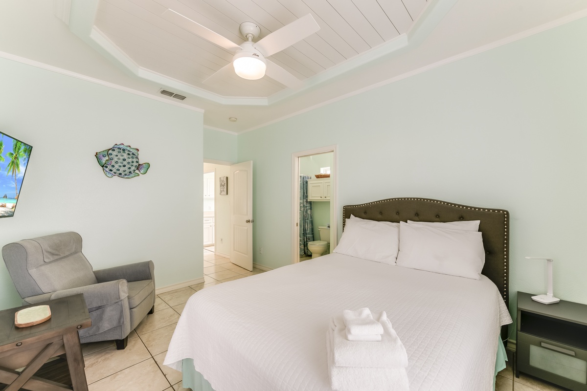 Your coastal retreat features a comfortable bed with crisp linens, beachy décor, and thoughtful touches that make this space feel like home.