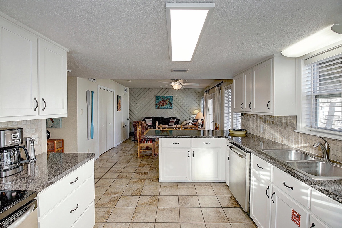 Your fully equipped kitchen features granite countertops and opens to a bright living area—perfect for cooking meals while staying connected with family.