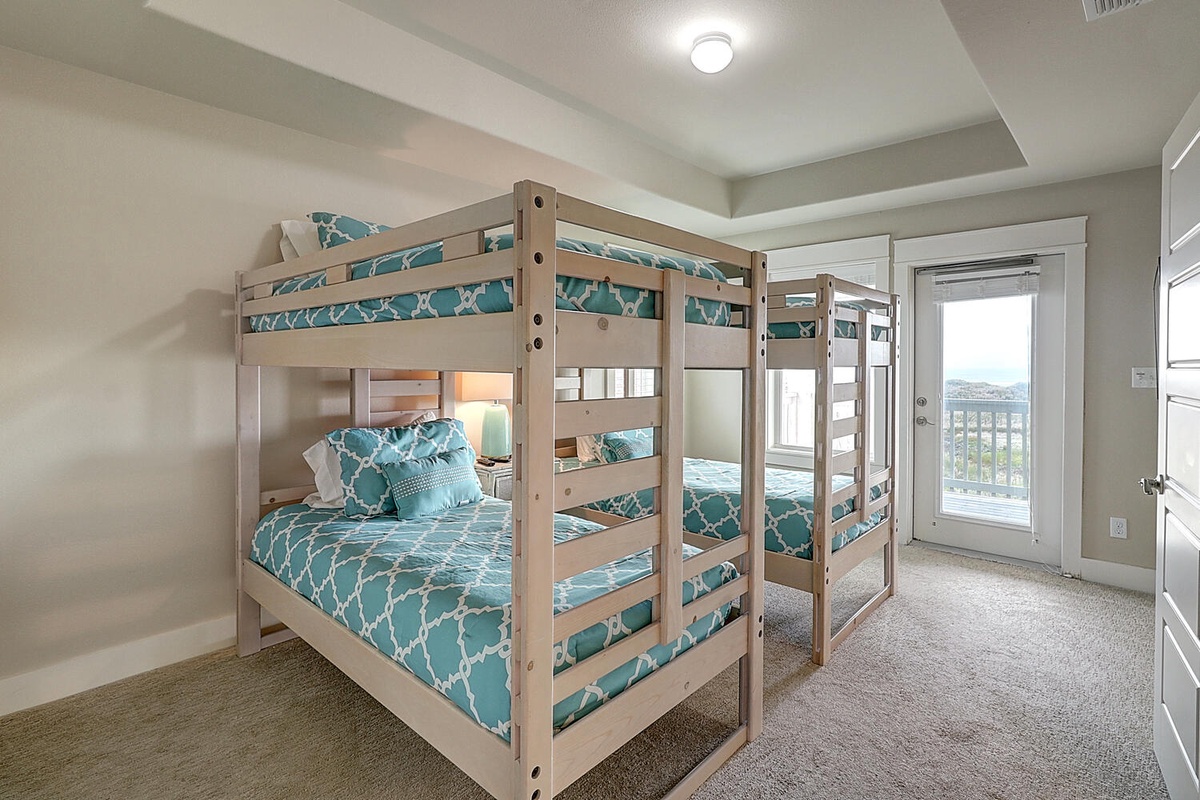 Your kids will love these cozy bunk beds with cheerful turquoise linens, perfect for creating lasting vacation memories together.