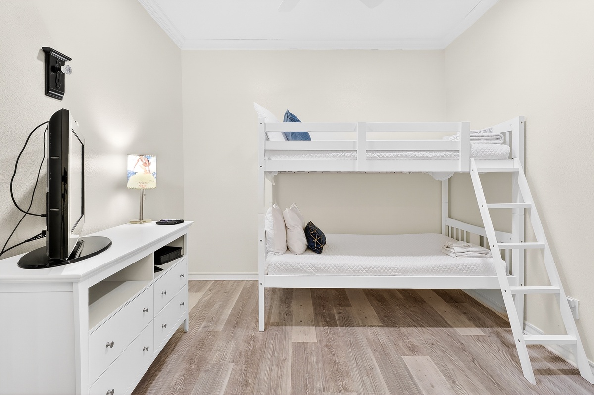 Your kids will love this bright bedroom with comfortable bunk beds and entertainment center for movie nights together.