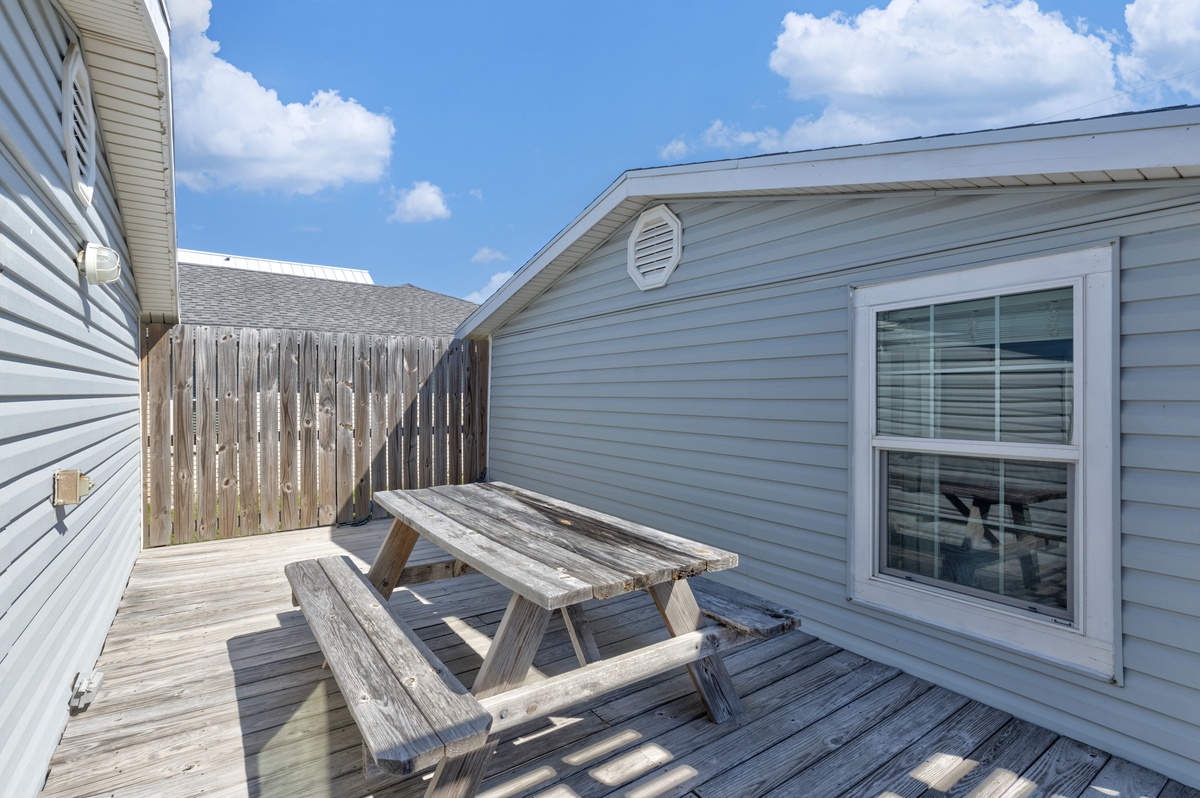 Step onto your private deck where a rustic picnic table awaits your morning coffee or evening meal under the open sky.