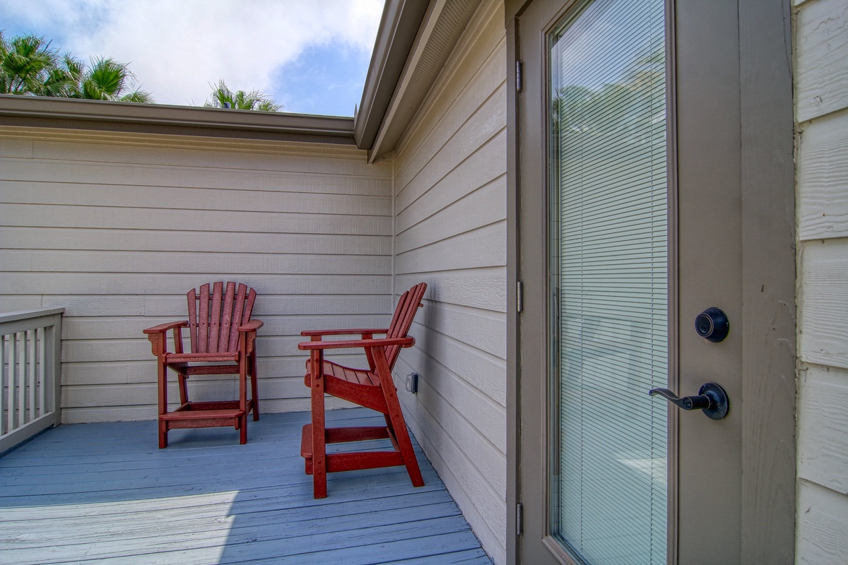 Step onto your private deck where red Adirondack chairs await. Sip morning coffee as palm trees sway overhead.