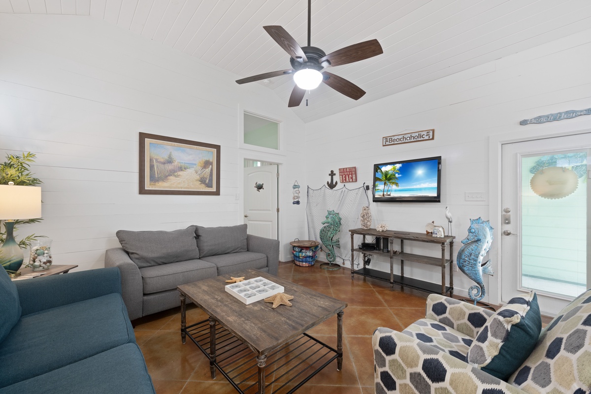 Sink into coastal comfort in your stylish living room, where beach-themed décor and plush seating create the perfect spot for relaxation.