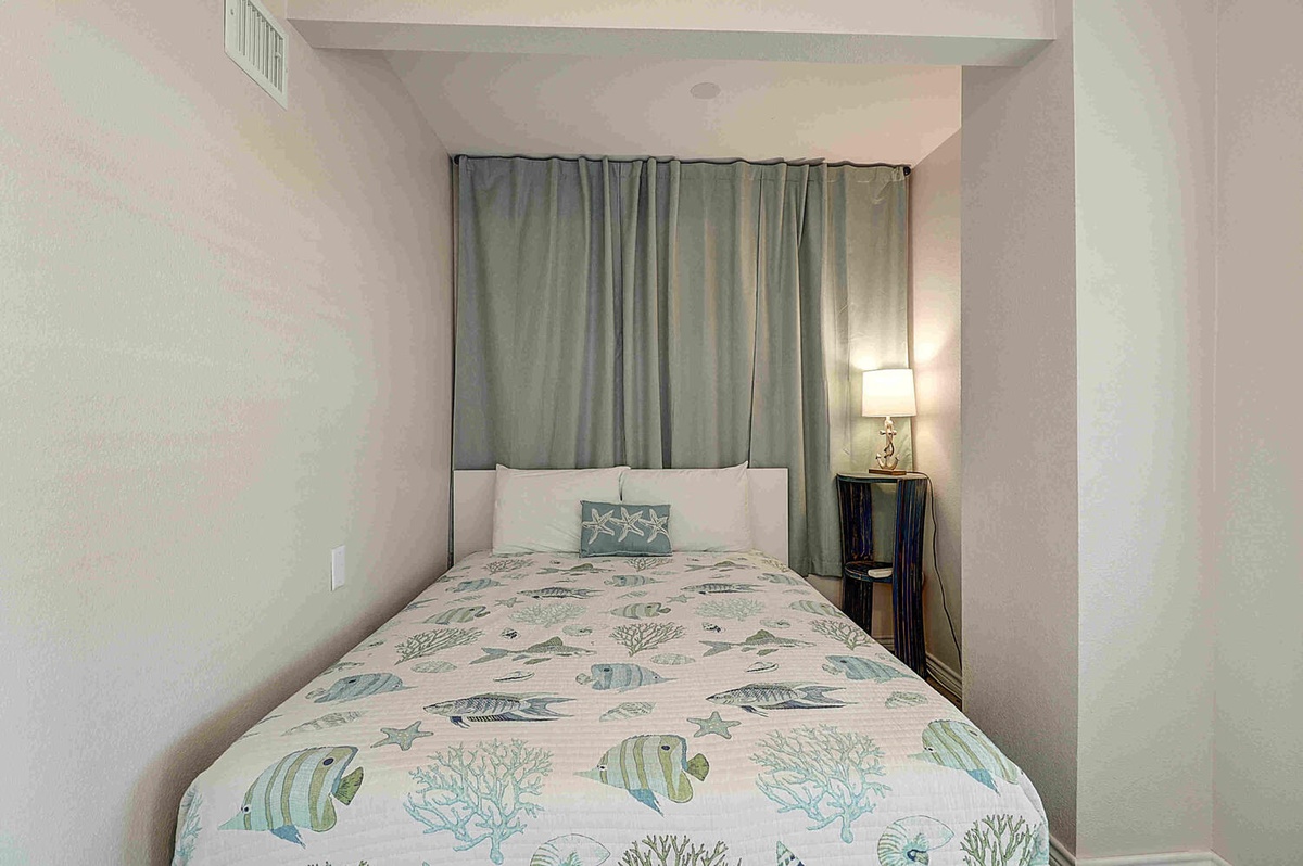 Drift into peaceful dreams in your cozy bedroom, complete with ocean-themed linens and soft lighting for ultimate relaxation.
