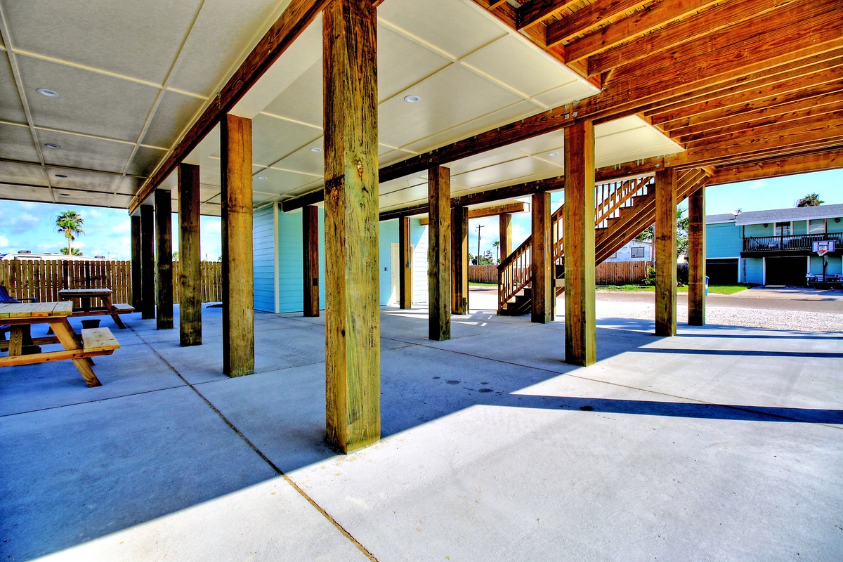 Your covered parking area offers protection from the elements, with rustic wooden beams and convenient access to your vacation home.
