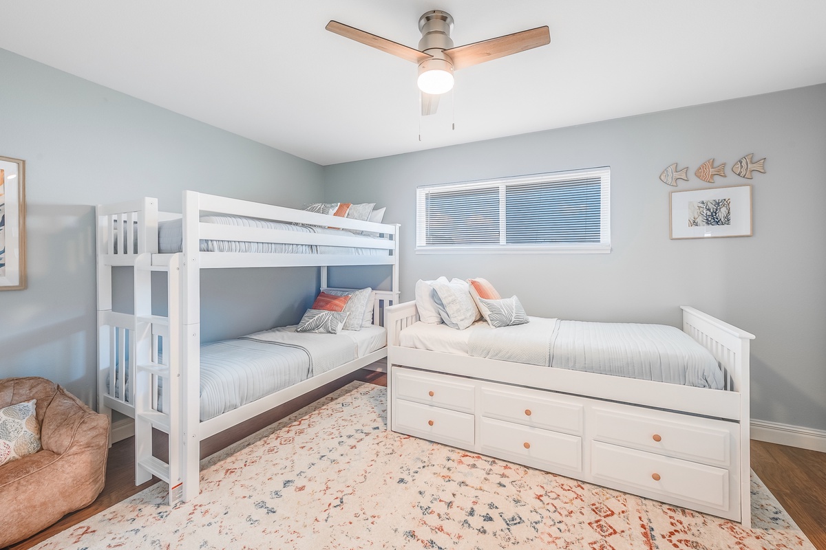 Your kids will love this cheerful bedroom with bunk bed and twin bed, perfect for family adventures together.