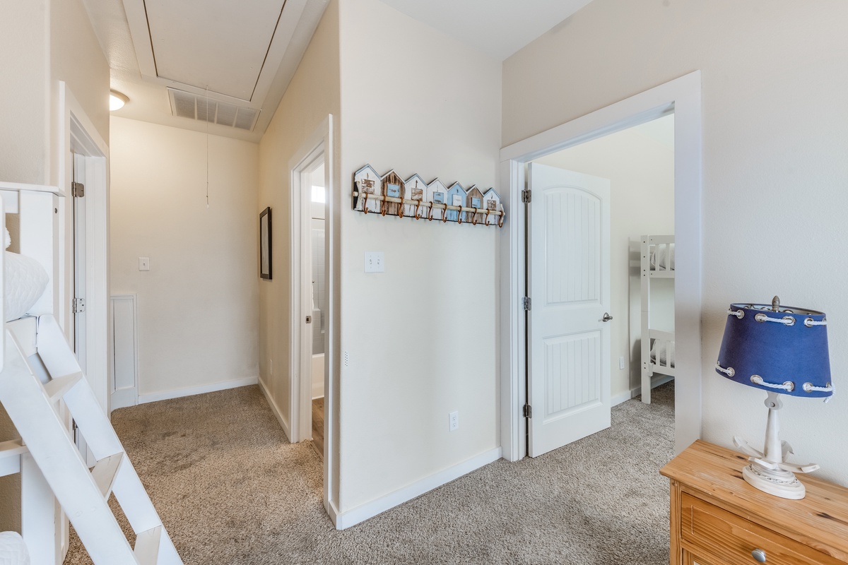Your cozy bedroom hallway features charming coastal touches and soft carpeting, creating a peaceful retreat for restful nights.