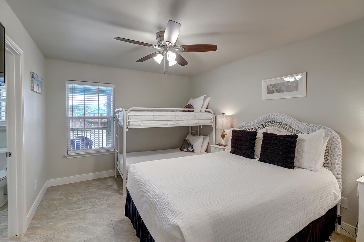 Your spacious bedroom features a comfortable bed plus bunk beds, perfect for families or groups seeking flexible sleeping arrangements.