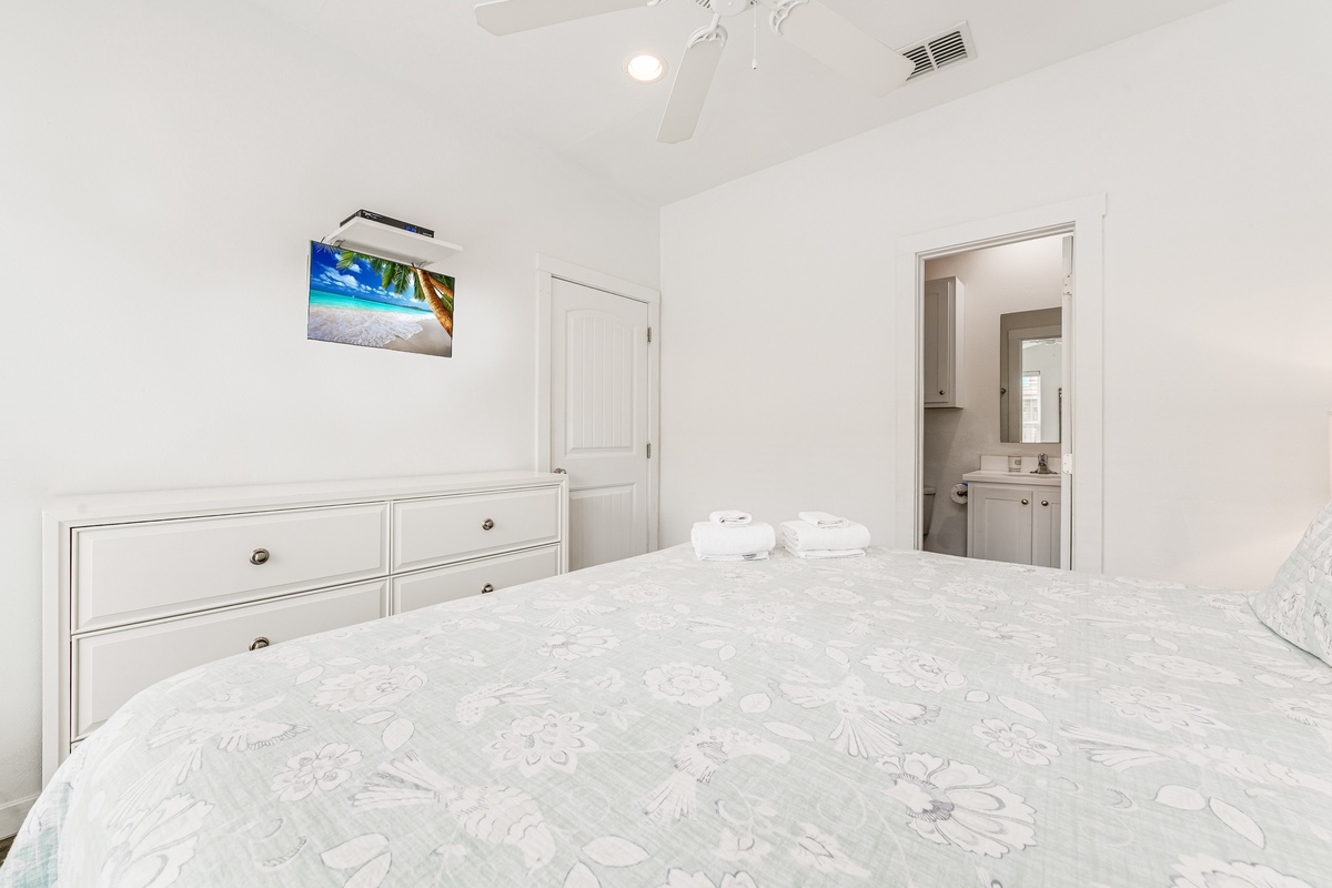 Unwind in this serene bedroom featuring crisp linens, modern amenities, and your own ensuite bathroom for ultimate comfort.