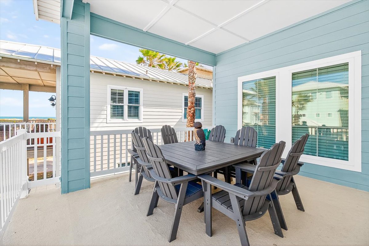 Gather your group around this spacious covered dining area, where coastal breezes and ocean glimpses create the perfect backdrop for memorable meals together.