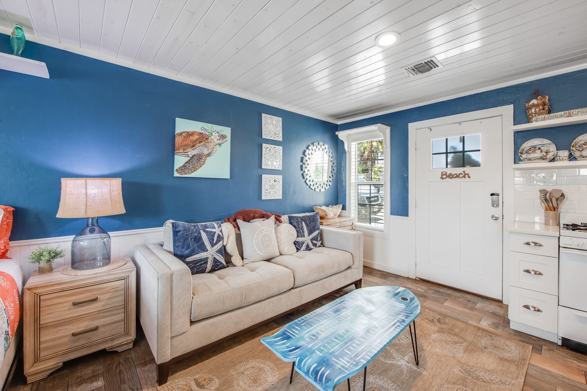 Relax in your coastal-themed living room with ocean blues, comfy seating, and charming nautical touches that make you feel steps from the shore.