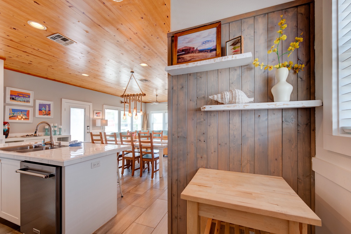 Gather around the spacious kitchen island where rustic wood meets modern convenience, perfect for cooking together and sharing meals.