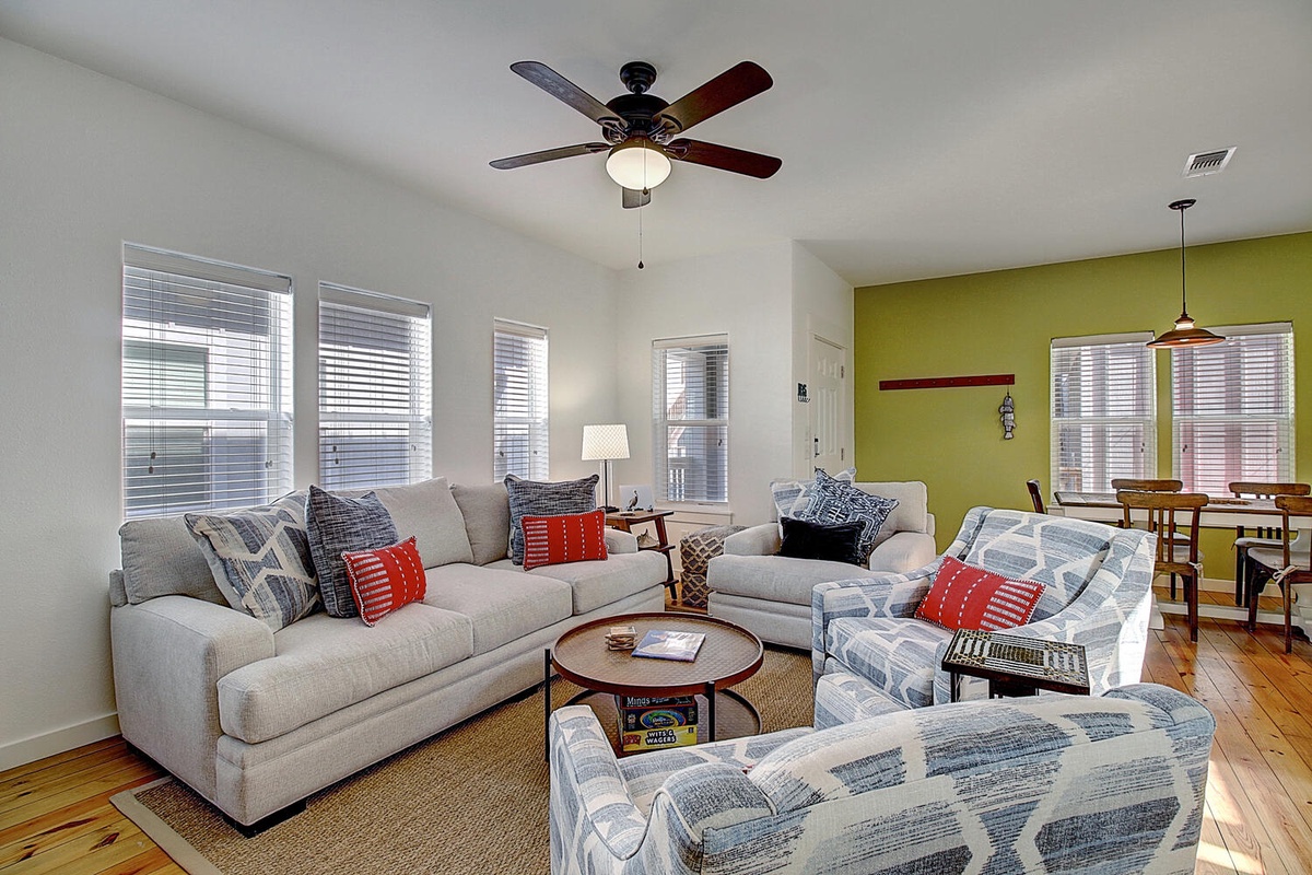 Sink into these plush sectional sofas where you'll unwind after exploring, with vibrant accents and natural light streaming through oversized windows.