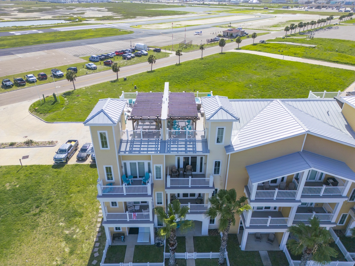 Expansive beachfront property with multiple levels and balconies offering stunning coastal views and convenient airport proximity.