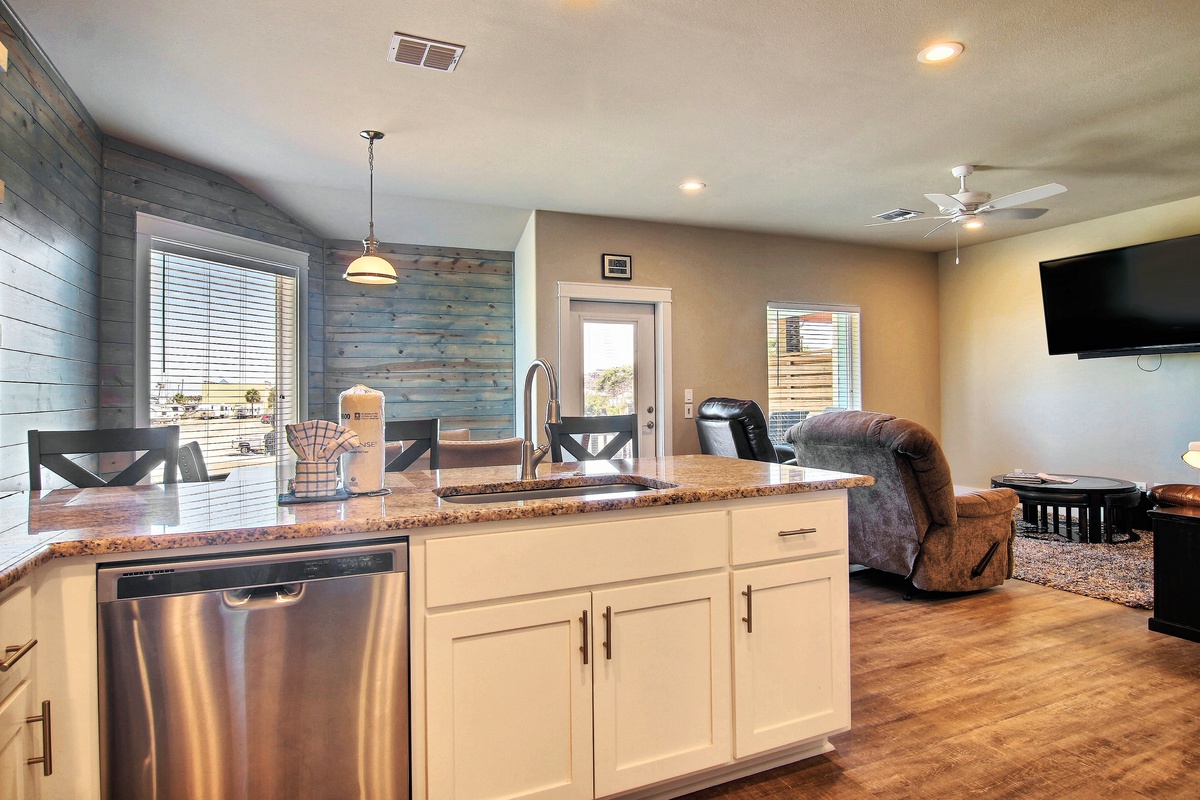 Your open kitchen flows into the living room, perfect for socializing while cooking with granite counters and stainless appliances.