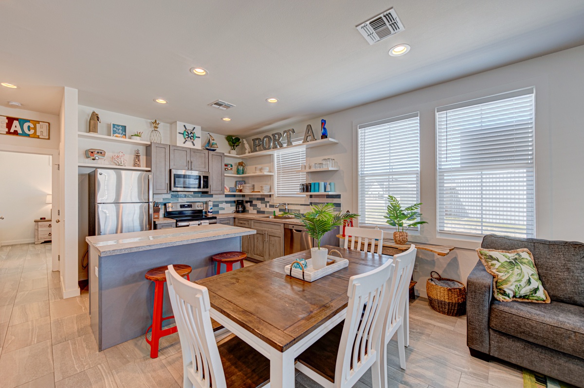 Gather around your spacious kitchen island while family meals simmer, then enjoy dining together at the rustic farmhouse table.