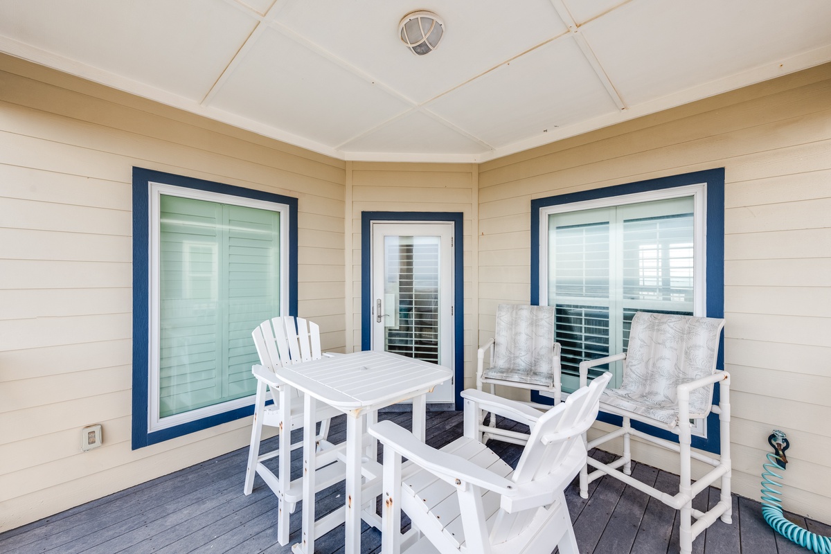 Relax on your private screened porch with coastal-inspired seating and dining space, perfect for morning coffee or evening meals.