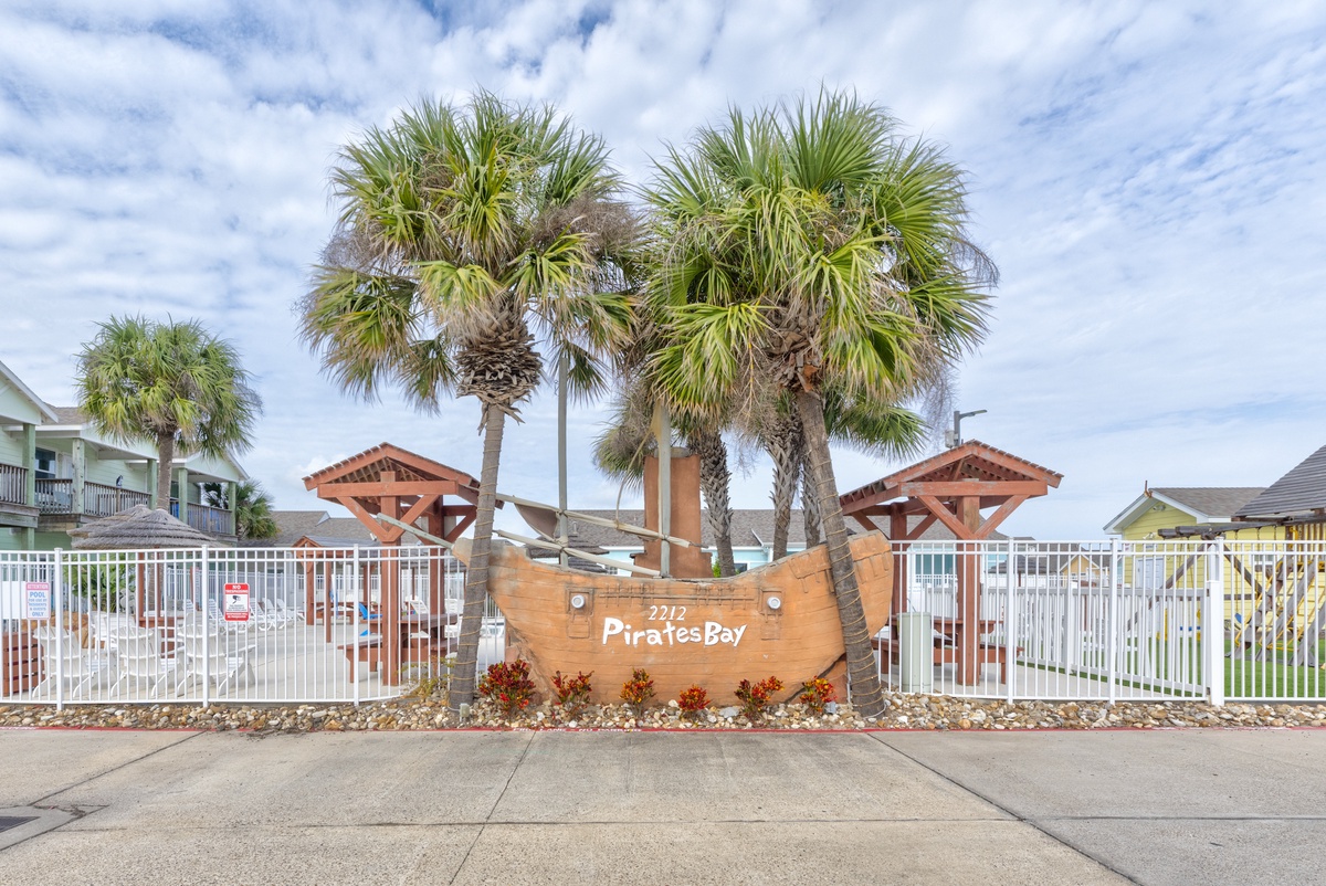 The Pirates Bay resort entrance welcomes guests with tropical palm trees and distinctive maritime-themed architecture.