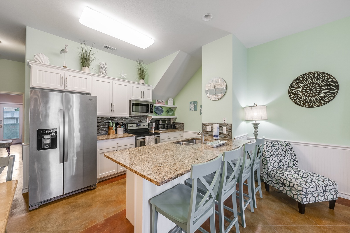 Your bright, spacious kitchen features granite counters, stainless appliances, and a breakfast bar where you can enjoy morning coffee.