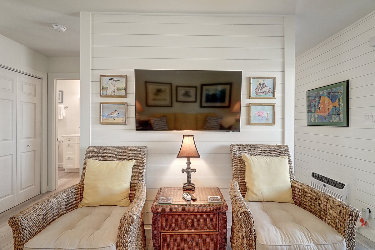 Sink into coastal charm with wicker chairs and nautical artwork in your peaceful sitting nook. The perfect spot to unwind with morning coffee.