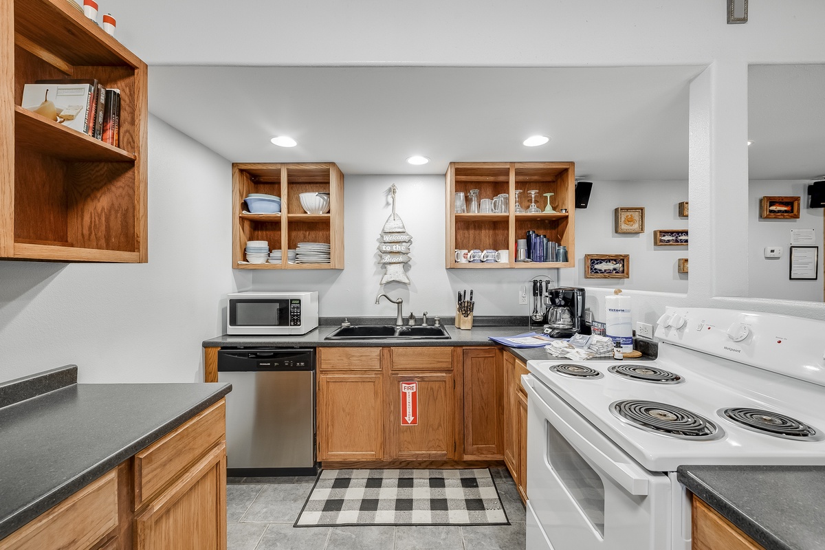 Your fully equipped kitchen awaits with warm wood cabinets, modern appliances, and everything needed for memorable meals together.